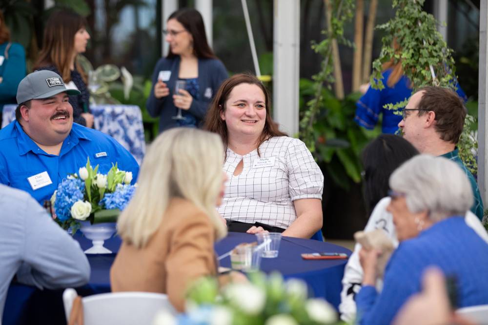 Shelby Harrison chatting with two coworkers